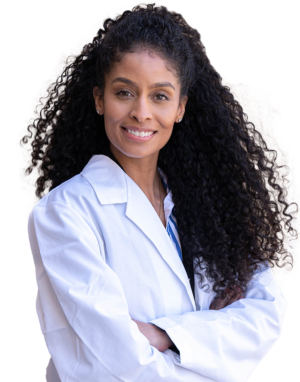 Woman with long curly hair wearing a white nurse's coat crossing her arms
