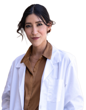 Young woman with two small golden necklaces smiling wearing a nurse coat over a bronze dress shirt