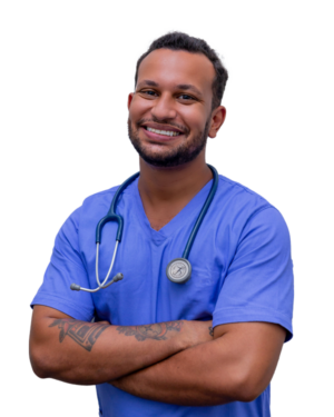young man with short brown hair wearing blue scrubs with a stethoscope around his neck while crossing his arms
