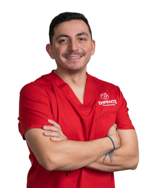 young man with short black hair wearing red scrubs crossing his arms